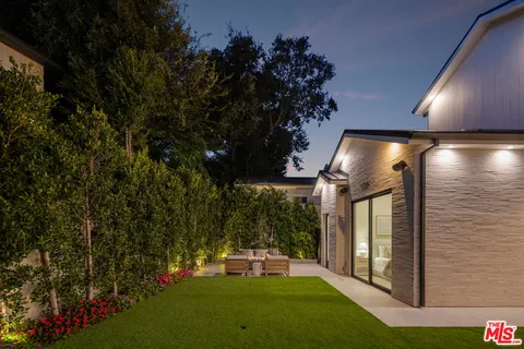 a view of a chair and tables in the patio