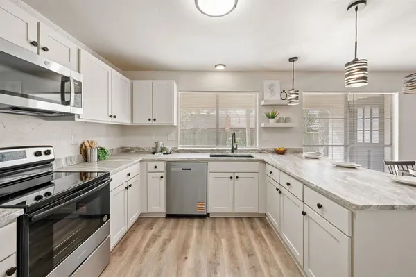 a kitchen with a sink stove and microwave