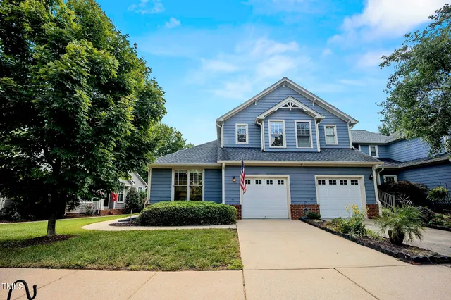 a view of house with yard and green space