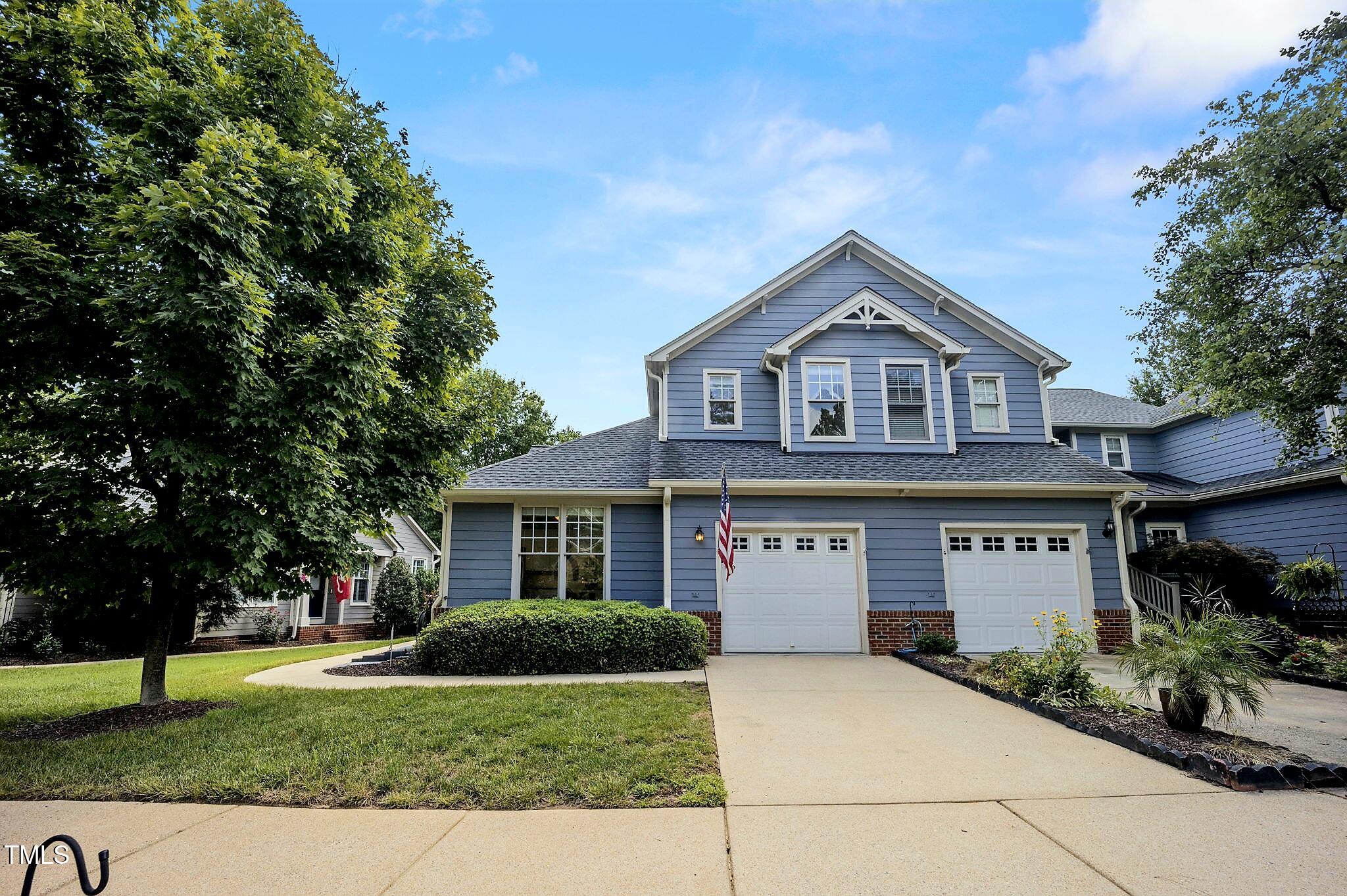 a view of house with yard and green space