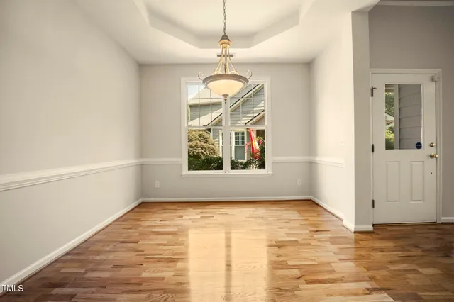 an empty room with closet and a ceiling fan