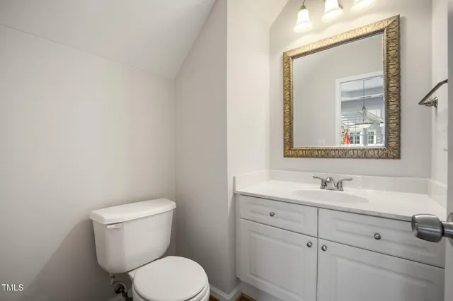 an empty room with closet and a chandelier fan