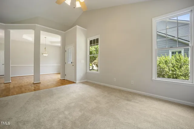an aerial view of a house with a lot of plants and lake view