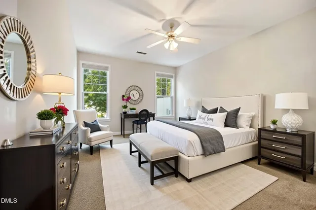 a spacious bedroom with a bed and a chandelier