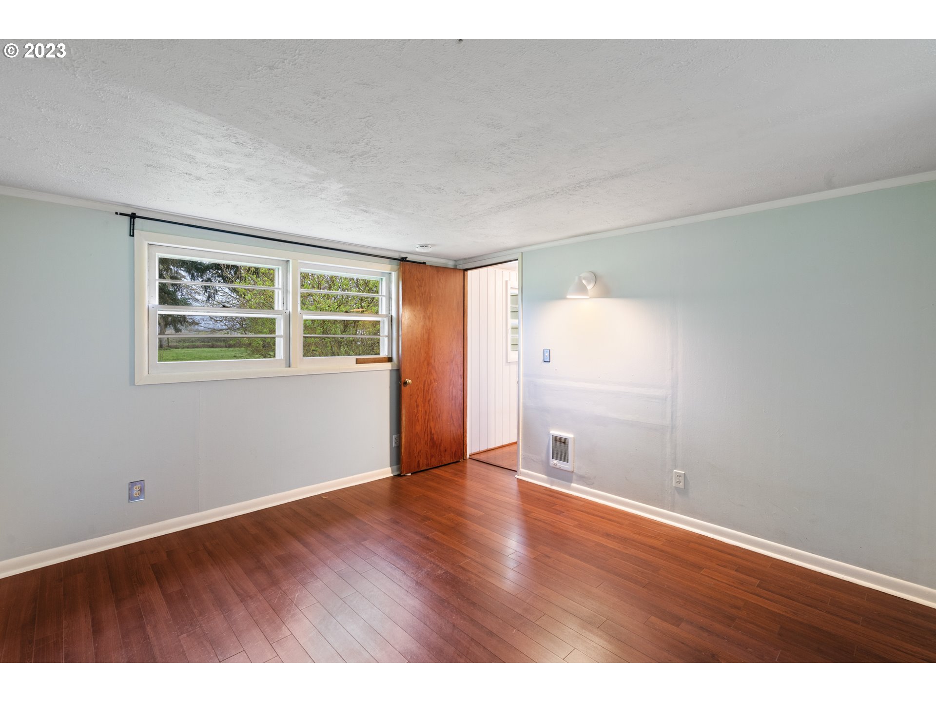 15200 Northwest Gillihan Road Portland, OR 97231 - Photo 27 of 42 a view of an empty room with wooden floor and a window