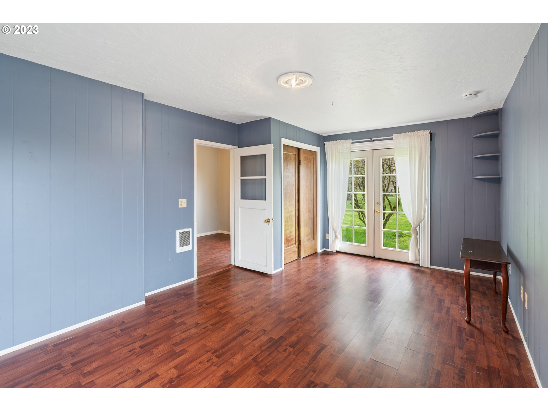15200 Northwest Gillihan Road Portland, OR 97231 - Photo 31 of 42 a view of an empty room with wooden floor and windows