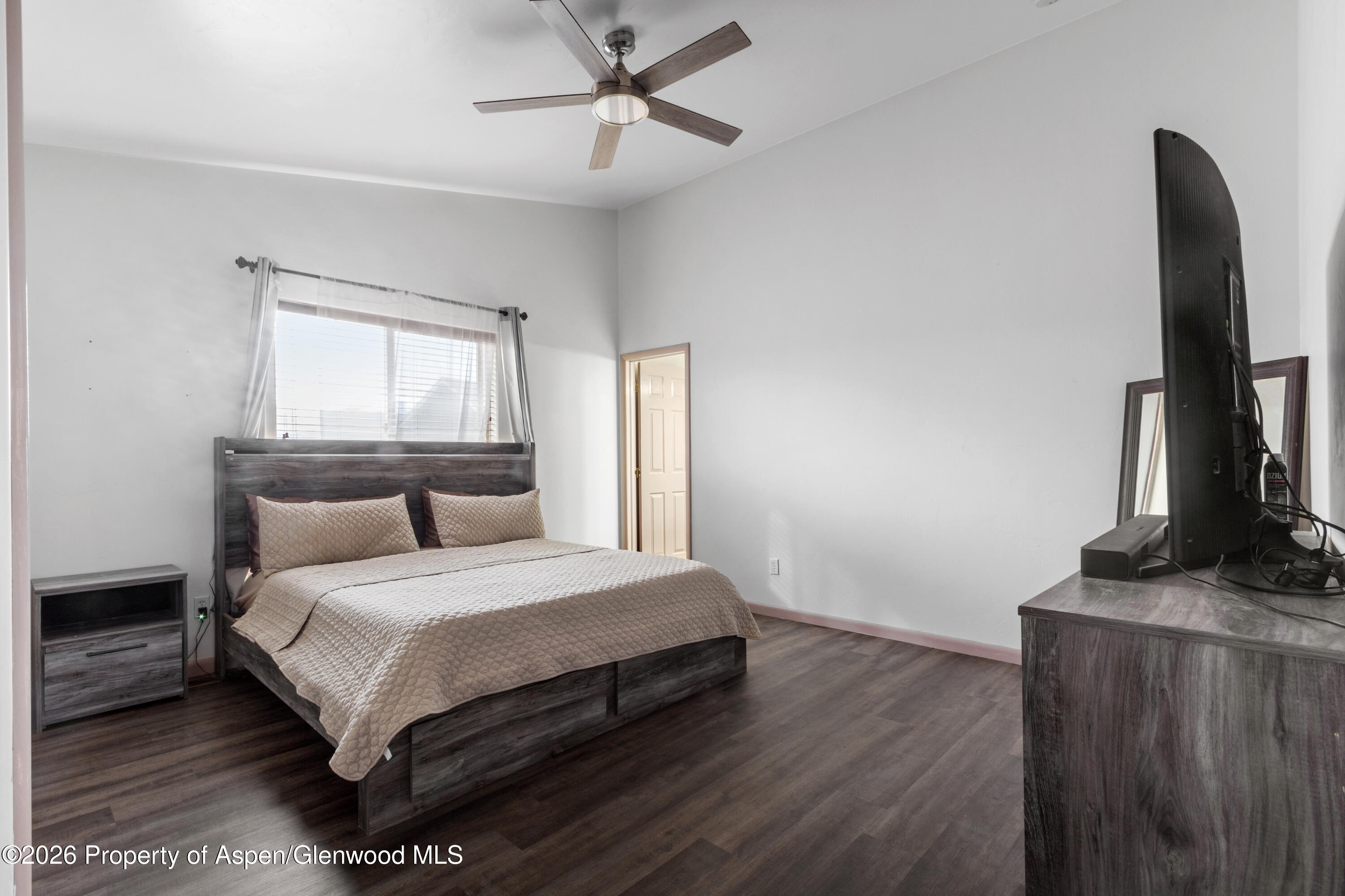 837 East 17th Street Rifle, CO 81650 - Photo 13 of 21 a bedroom with a bed flat screen tv and window