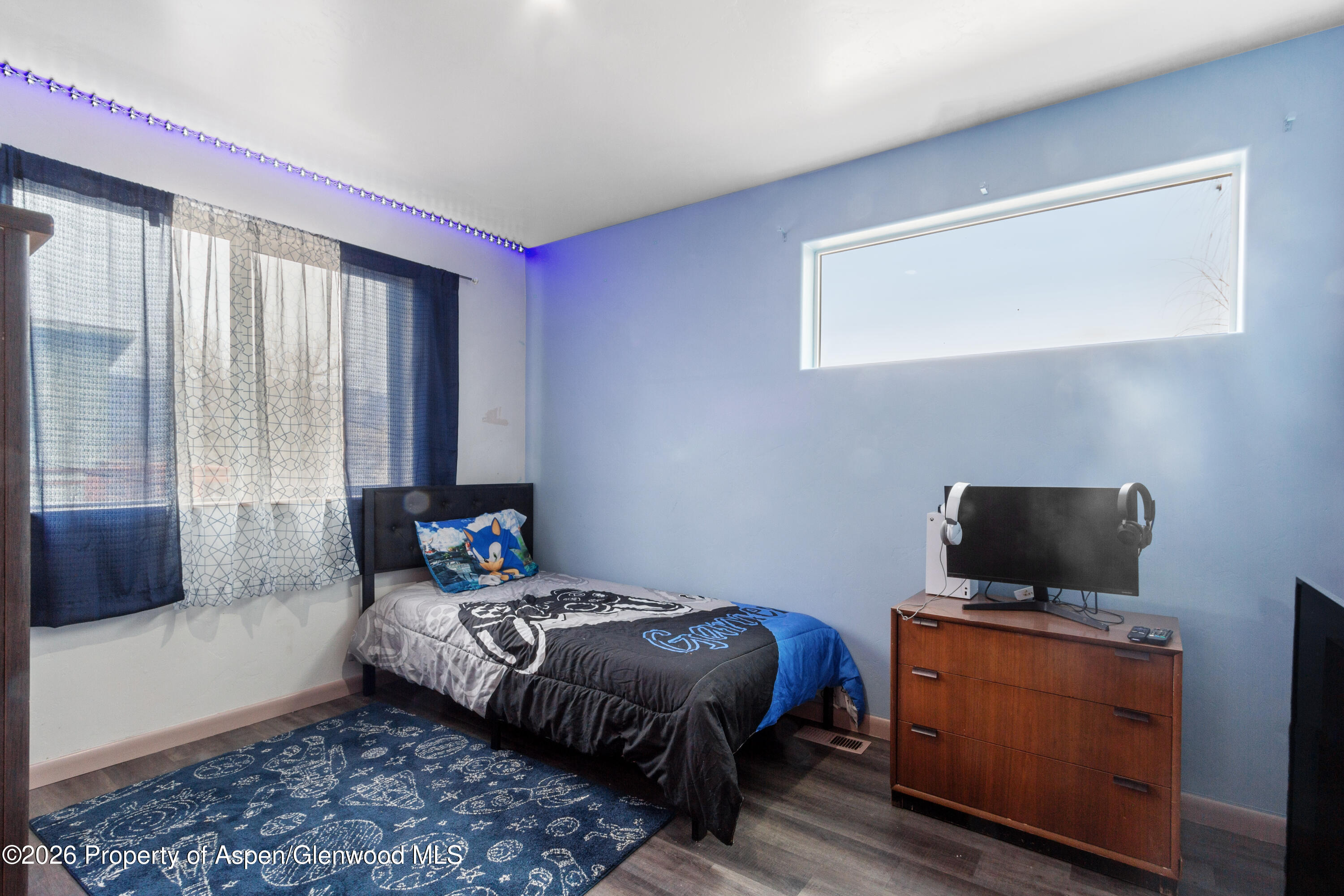 837 East 17th Street Rifle, CO 81650 - Photo 17 of 21 a bedroom with a bed and flat screen tv