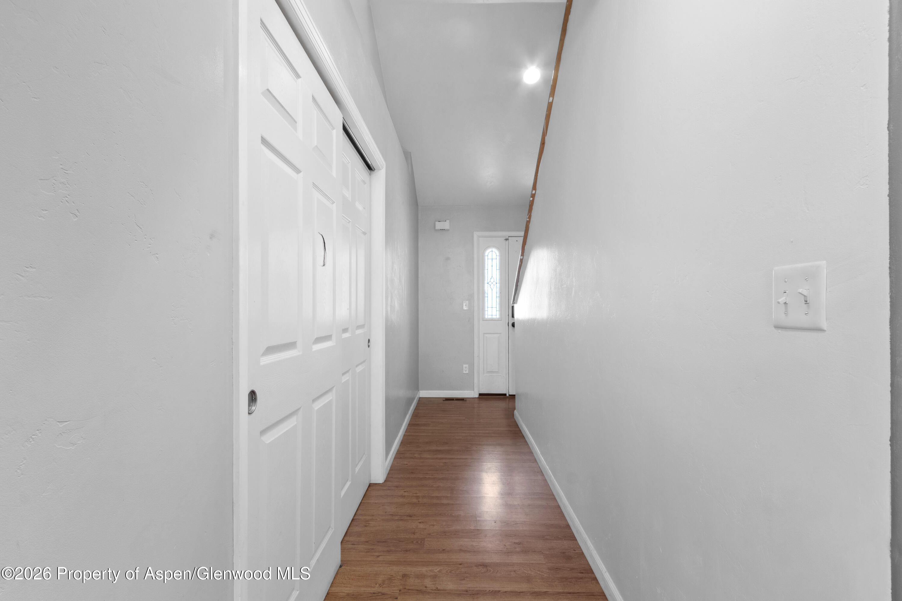 837 East 17th Street Rifle, CO 81650 - Photo 2 of 21 a view of a hallway with wooden floor and staircase