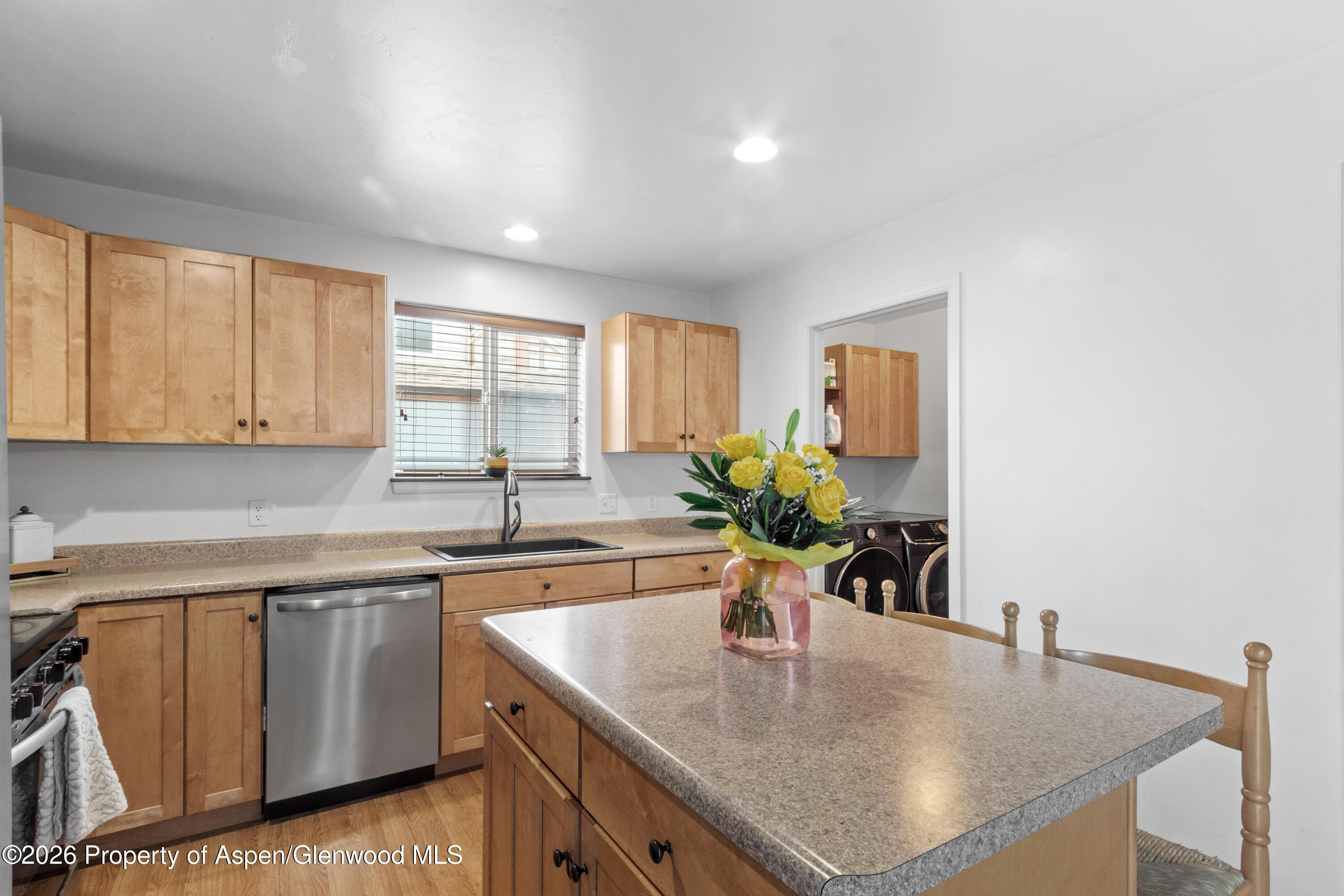 837 East 17th Street Rifle, CO 81650 - Photo 9 of 21 a kitchen with stainless steel appliances granite countertop a sink a counter space and a window