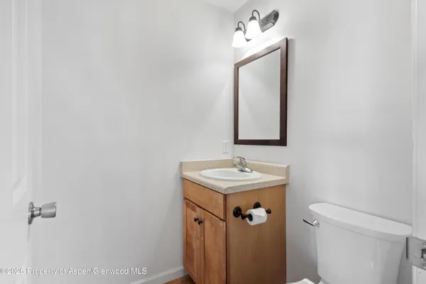 a bathroom with a sink a mirror and a toilet