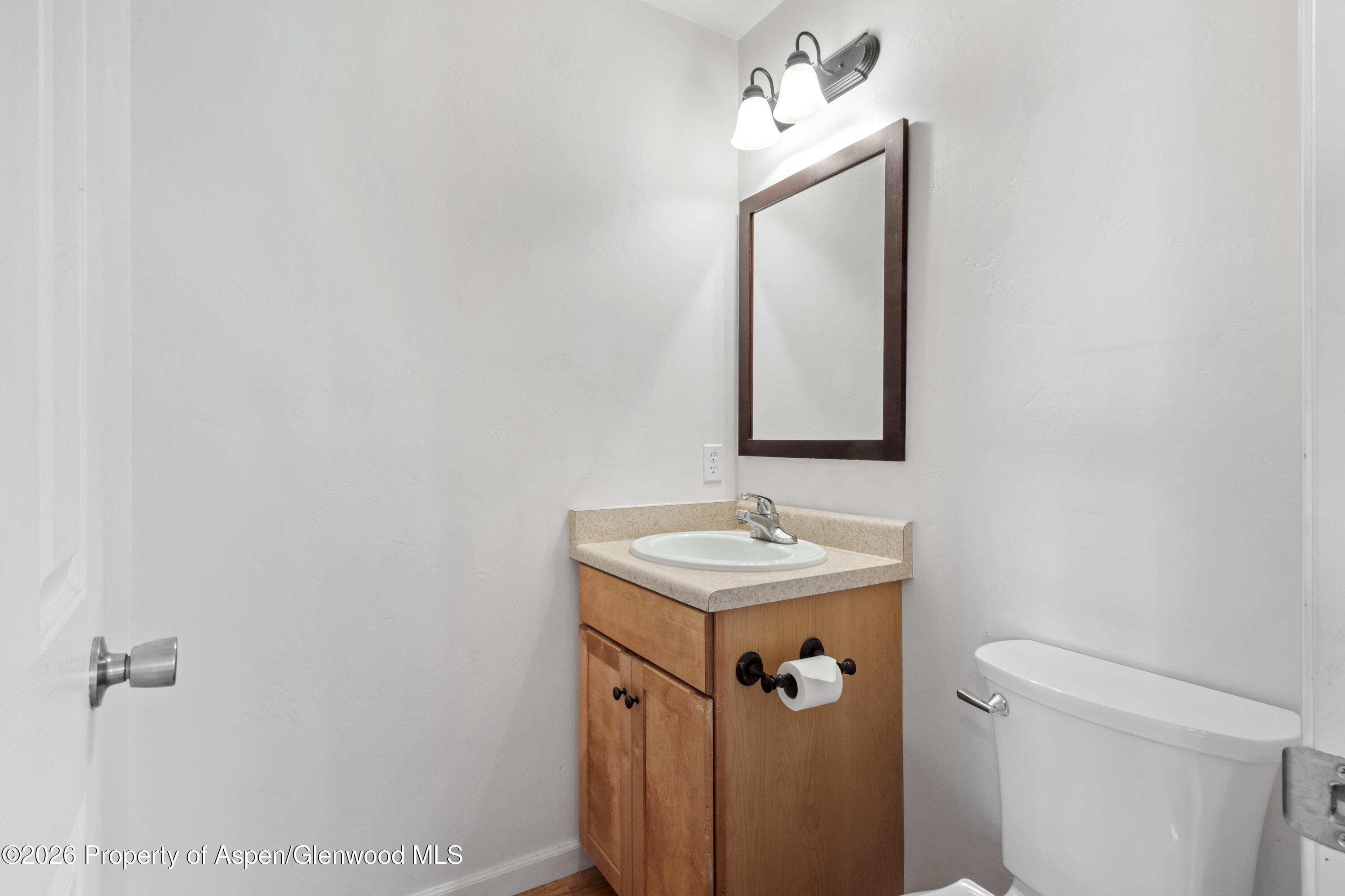837 East 17th Street Rifle, CO 81650 - Photo 10 of 21 a bathroom with a sink a mirror and a toilet