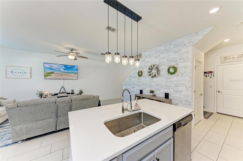 11637 Woodleaf Drive Lakewood Ranch, FL 34211 - Photo 16 of 54 a kitchen with a sink and a refrigerator
