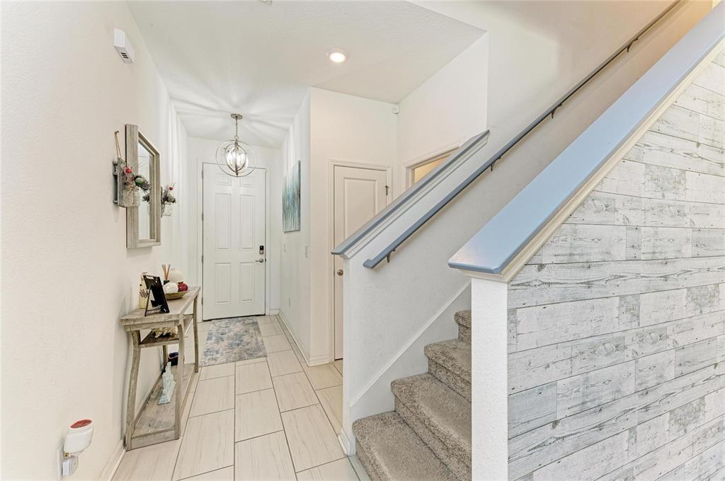 11637 Woodleaf Drive Lakewood Ranch, FL 34211 - Photo 19 of 54 a view of an entryway with wooden floor and staircase