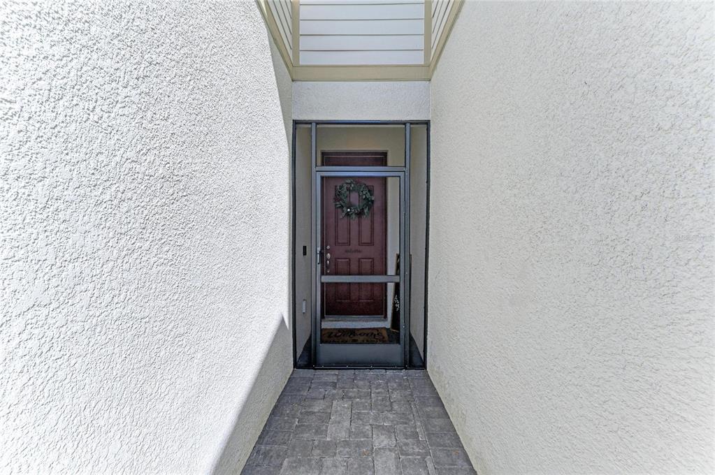11637 Woodleaf Drive Lakewood Ranch, FL 34211 - Photo 2 of 54 a view of a hallway with wooden floor and a hallway