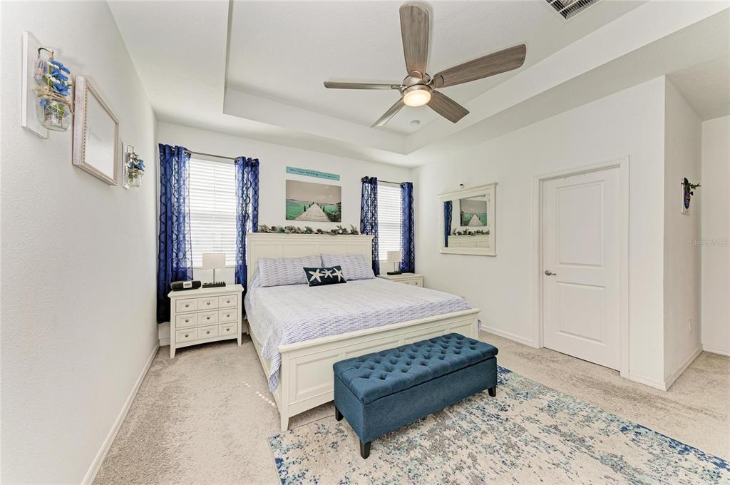 11637 Woodleaf Drive Lakewood Ranch, FL 34211 - Photo 22 of 54 a spacious bedroom with a bed and ceiling fan