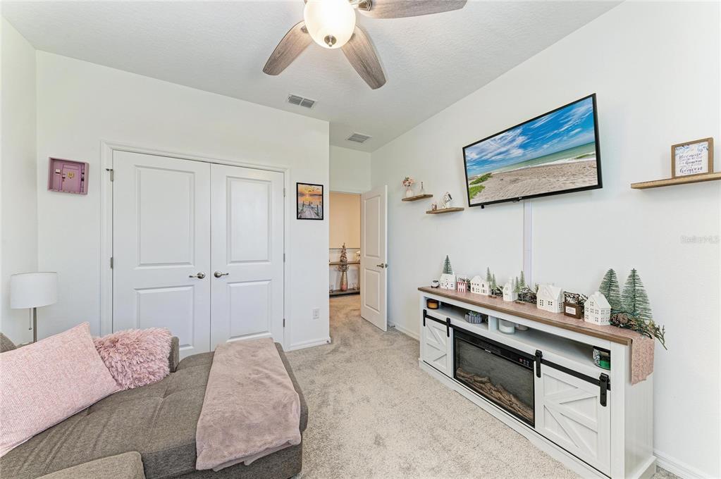 11637 Woodleaf Drive Lakewood Ranch, FL 34211 - Photo 27 of 54 a bedroom with furniture and a chandelier