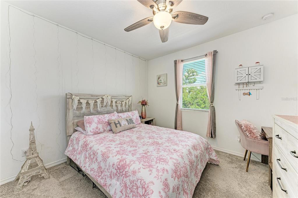 11637 Woodleaf Drive Lakewood Ranch, FL 34211 - Photo 30 of 54 a bedroom with a bed and a chandelier