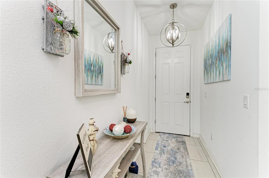 11637 Woodleaf Drive Lakewood Ranch, FL 34211 - Photo 3 of 54 a view of dining room with furniture and wooden floor