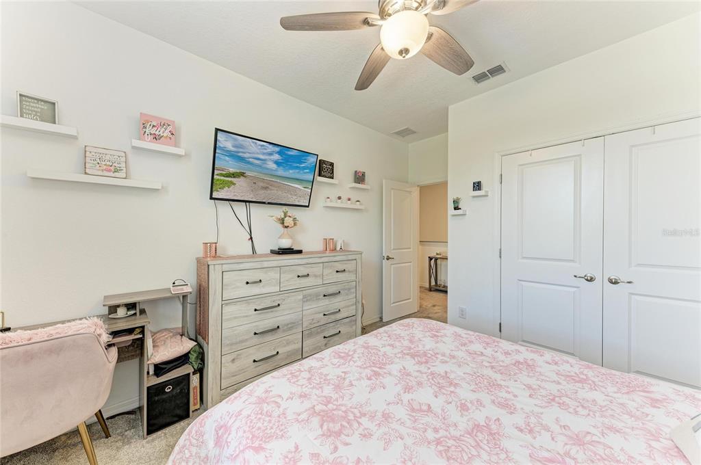 11637 Woodleaf Drive Lakewood Ranch, FL 34211 - Photo 31 of 54 a bedroom with a bed and a chandelier