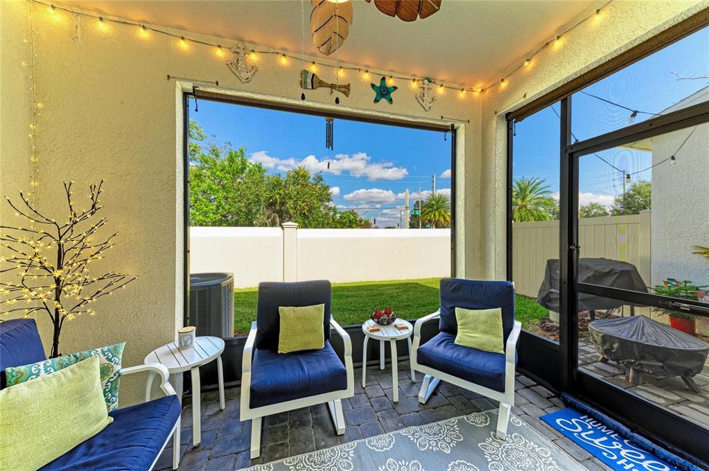 11637 Woodleaf Drive Lakewood Ranch, FL 34211 - Photo 33 of 54 a outdoor living room with furniture a rug and a floor to ceiling window