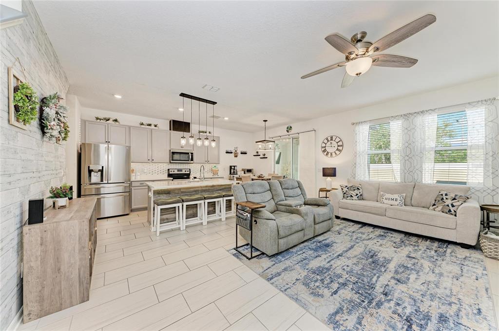 11637 Woodleaf Drive Lakewood Ranch, FL 34211 - Photo 4 of 54 a living room with furniture and a large window