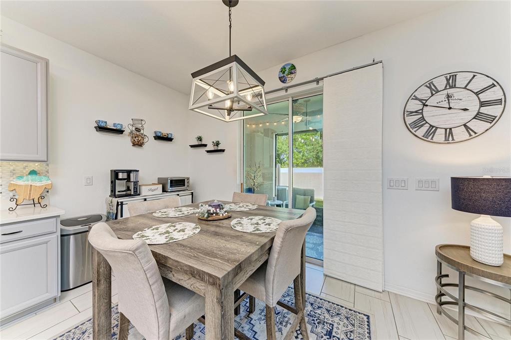 11637 Woodleaf Drive Lakewood Ranch, FL 34211 - Photo 8 of 54 a view of a dining room with furniture window and wooden floor