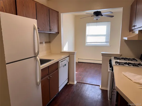 a kitchen with a refrigerator sink stove and cabinets
