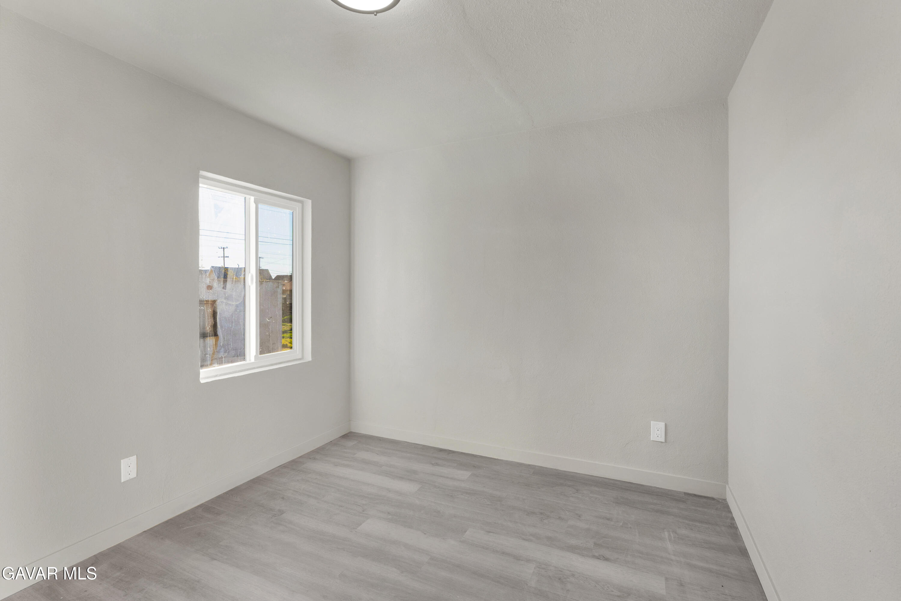 2494 Nadean Mojave, CA 93501 - Photo 15 of 19 a view of an empty room with wooden floor and a window