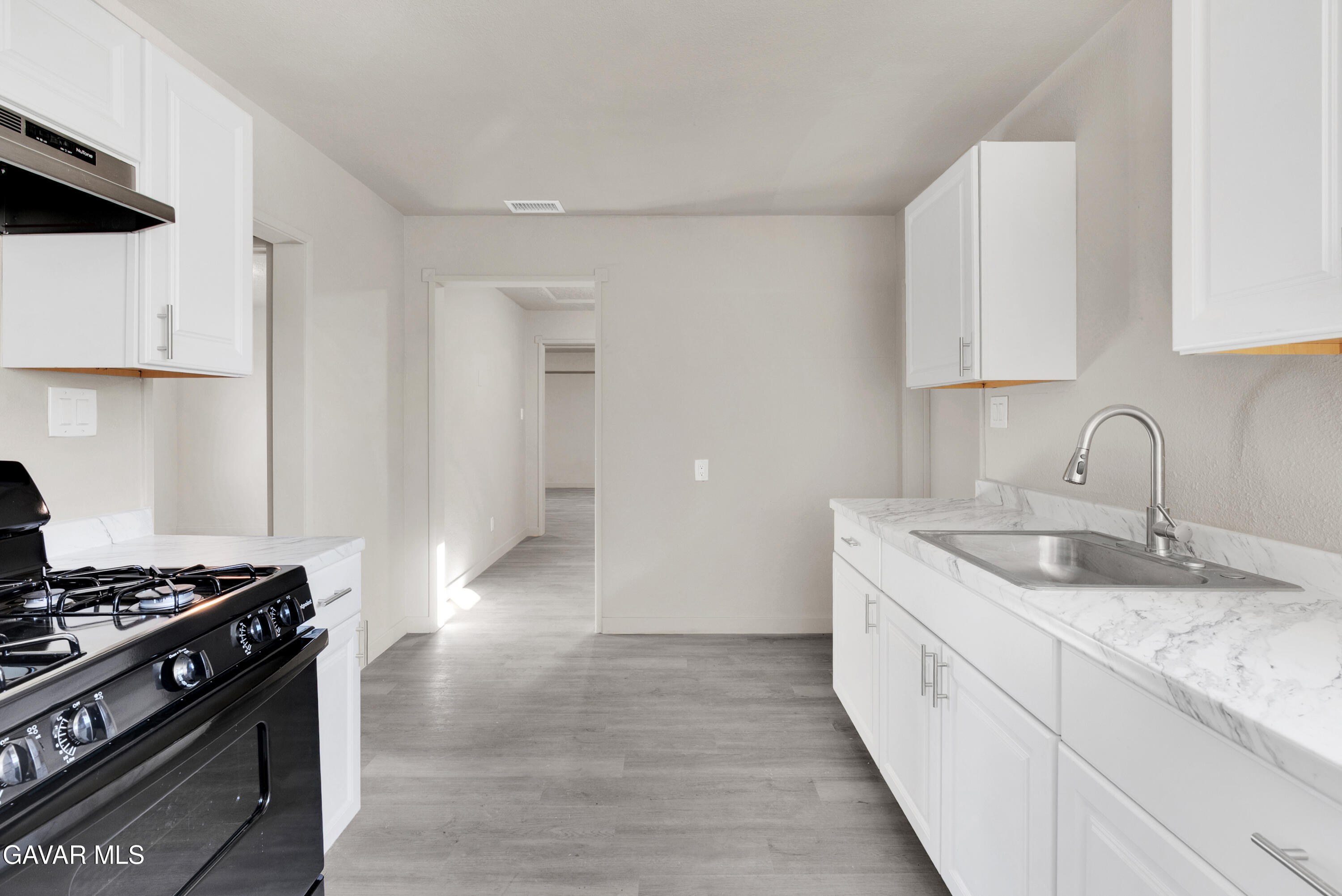2494 Nadean Mojave, CA 93501 - Photo 2 of 19 a kitchen with granite countertop a sink stove and cabinets