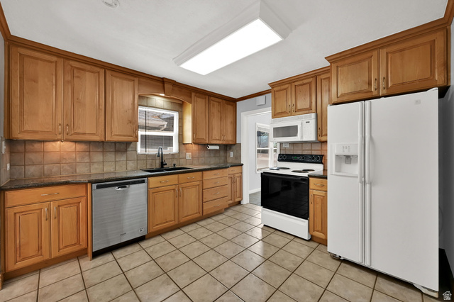 291 800 East Bountiful, UT 84010 - Photo 7 of 20 Kitchen with wood cabinetry, dark countertops, and a tiled backsplash
