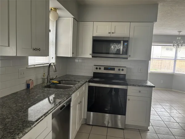 a kitchen with a stove and a microwave