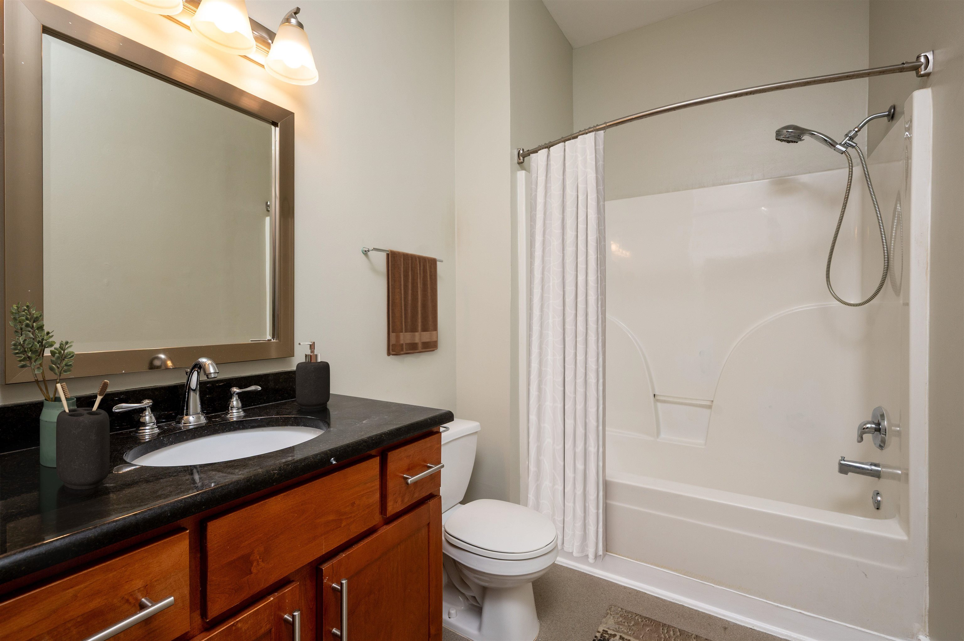505 Tennessee Street, Unit 407 Memphis, TN 38103 - Photo 4 of 27 a bathroom with a granite countertop sink toilet and shower
