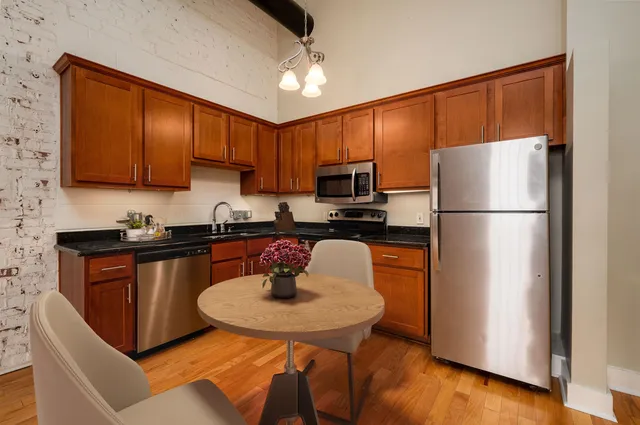 a kitchen with a refrigerator a stove a sink and a cabinets