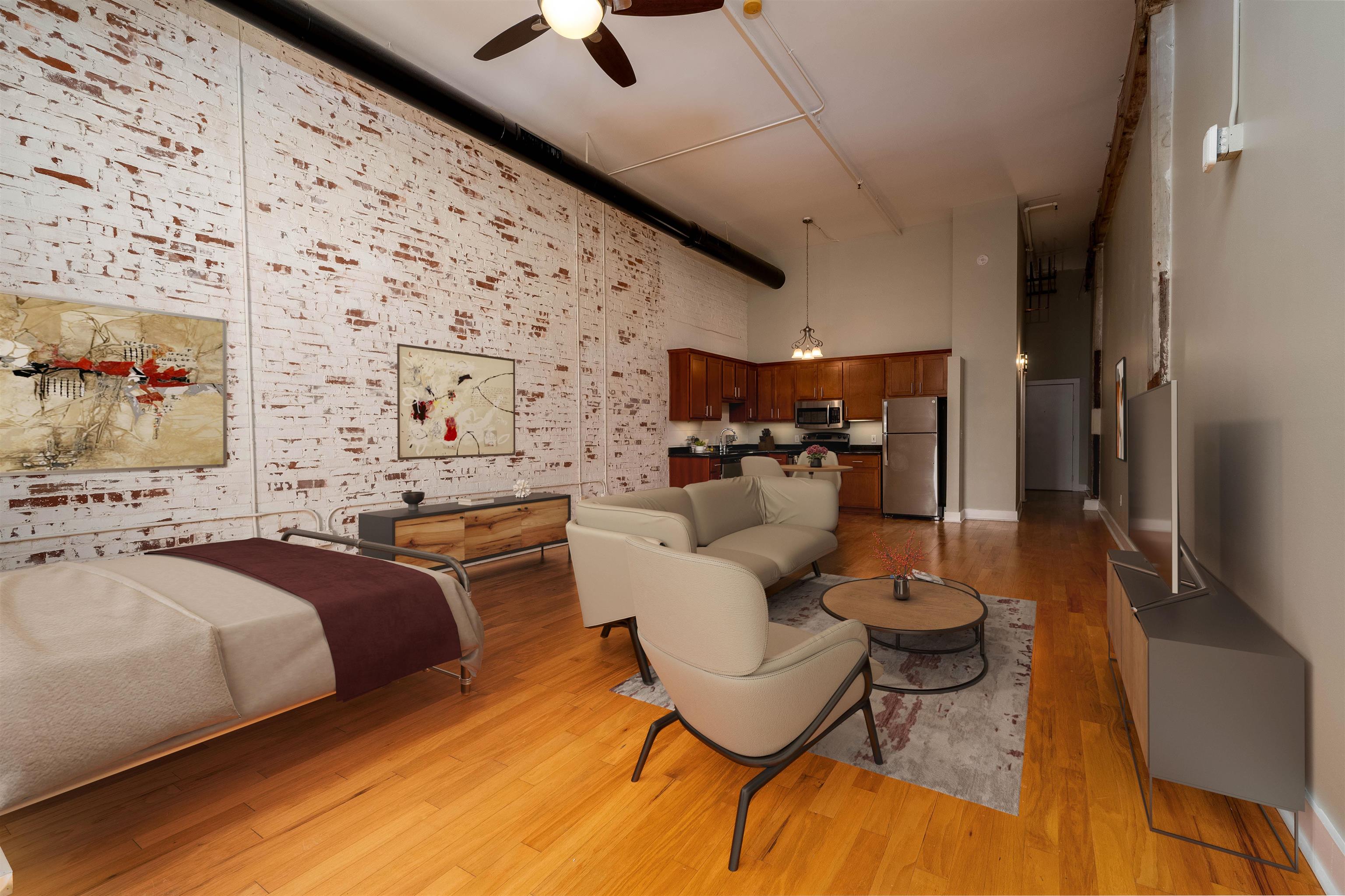 505 Tennessee Street, Unit 407 Memphis, TN 38103 - Photo 8 of 27 a bedroom with a bed and wooden floor