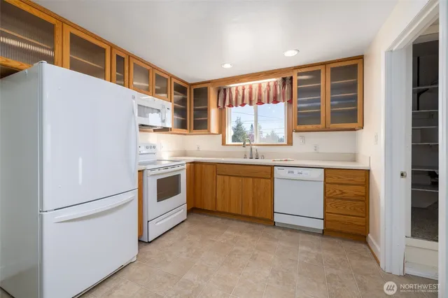 a kitchen with stainless steel appliances granite countertop a stove and a refrigerator