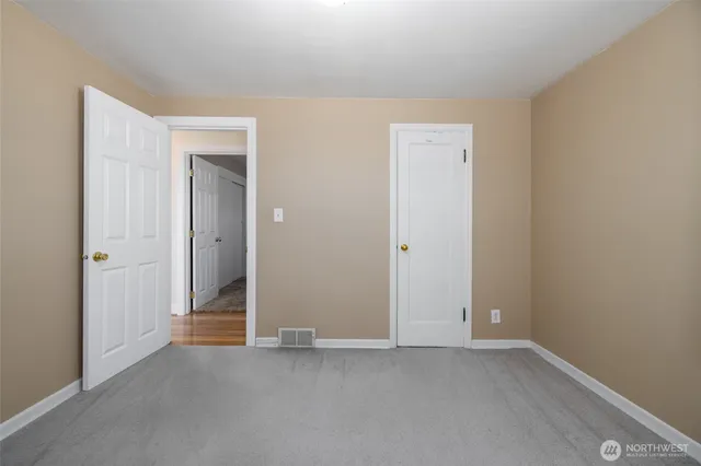 an empty room with closet area
