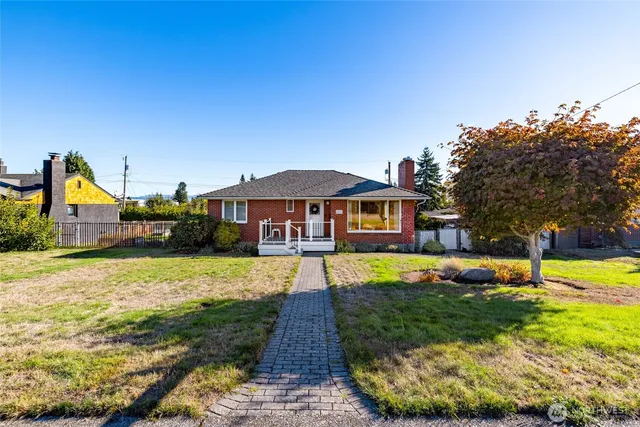 a front view of house with yard and green space