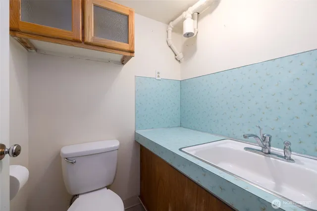 a bathroom with a sink a toilet and mirror