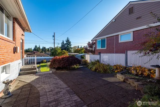 a view of a house with a yard and sitting area