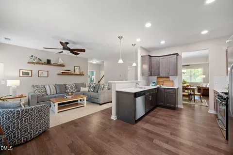 a large white kitchen with lots of counter space a sink and appliances