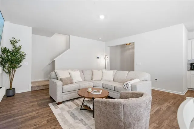 a kitchen with stainless steel appliances granite countertop a table chairs sink refrigerator and microwave