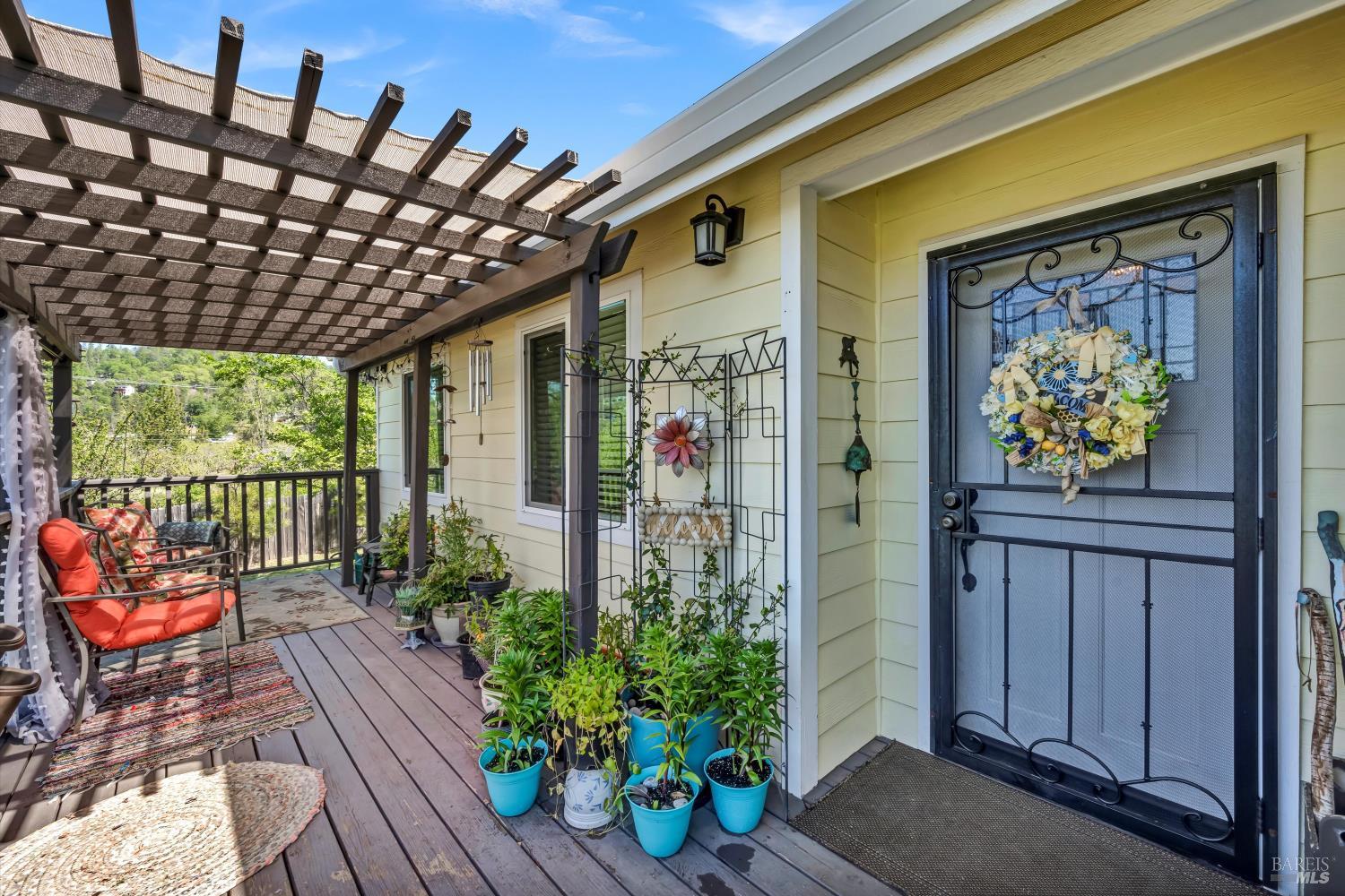 a porch with seating space and potted plant