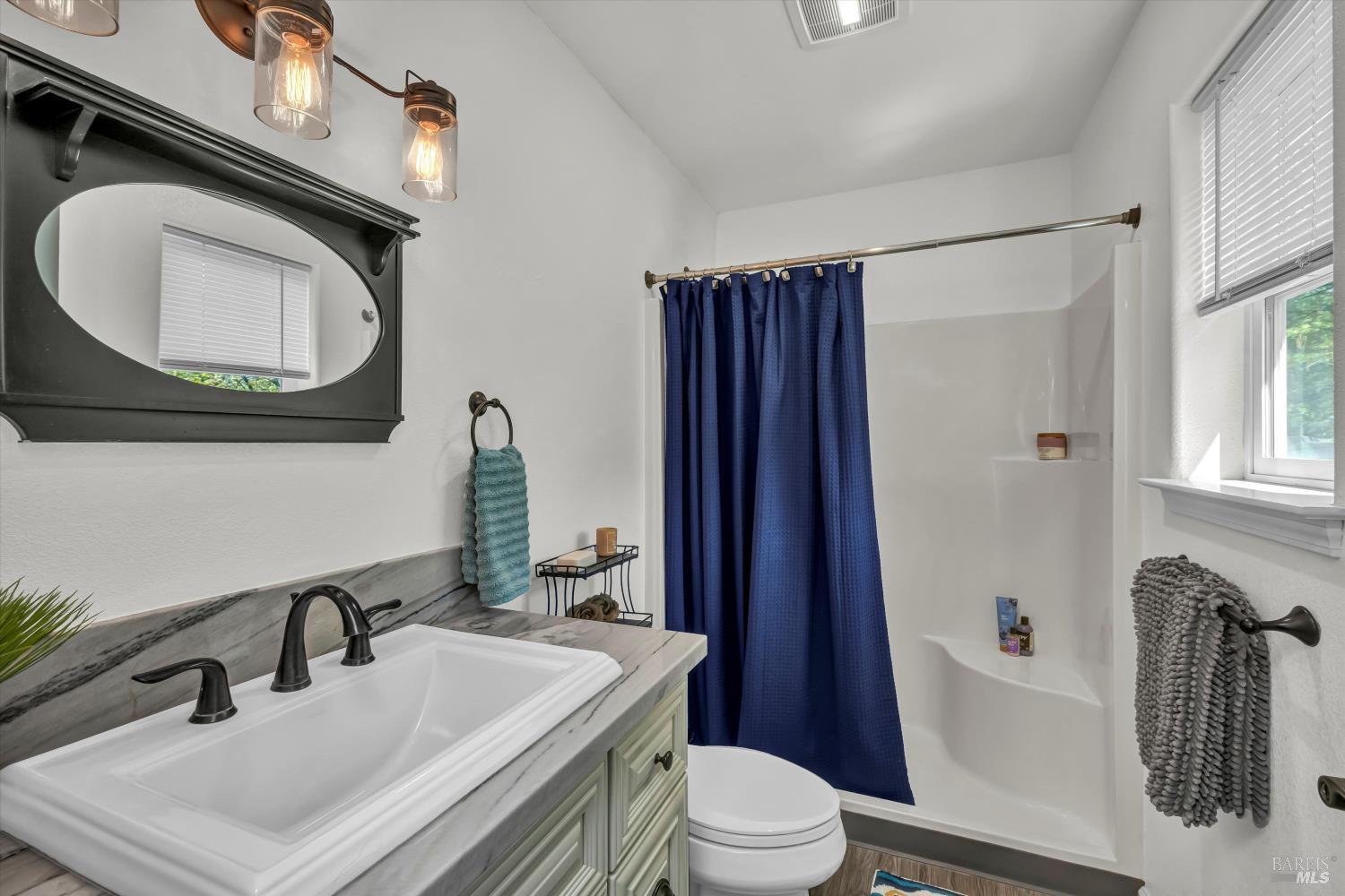 15314 Summit Boulevard Cobb, CA 95426 - Photo 15 of 29 a bathroom with a sink a toilet and a mirror