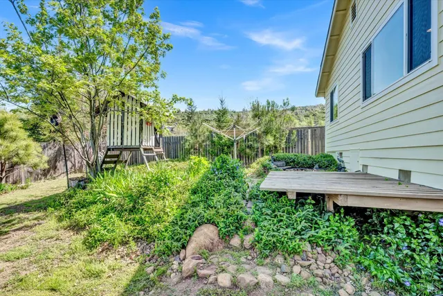a view of a wooden bench in a backyard