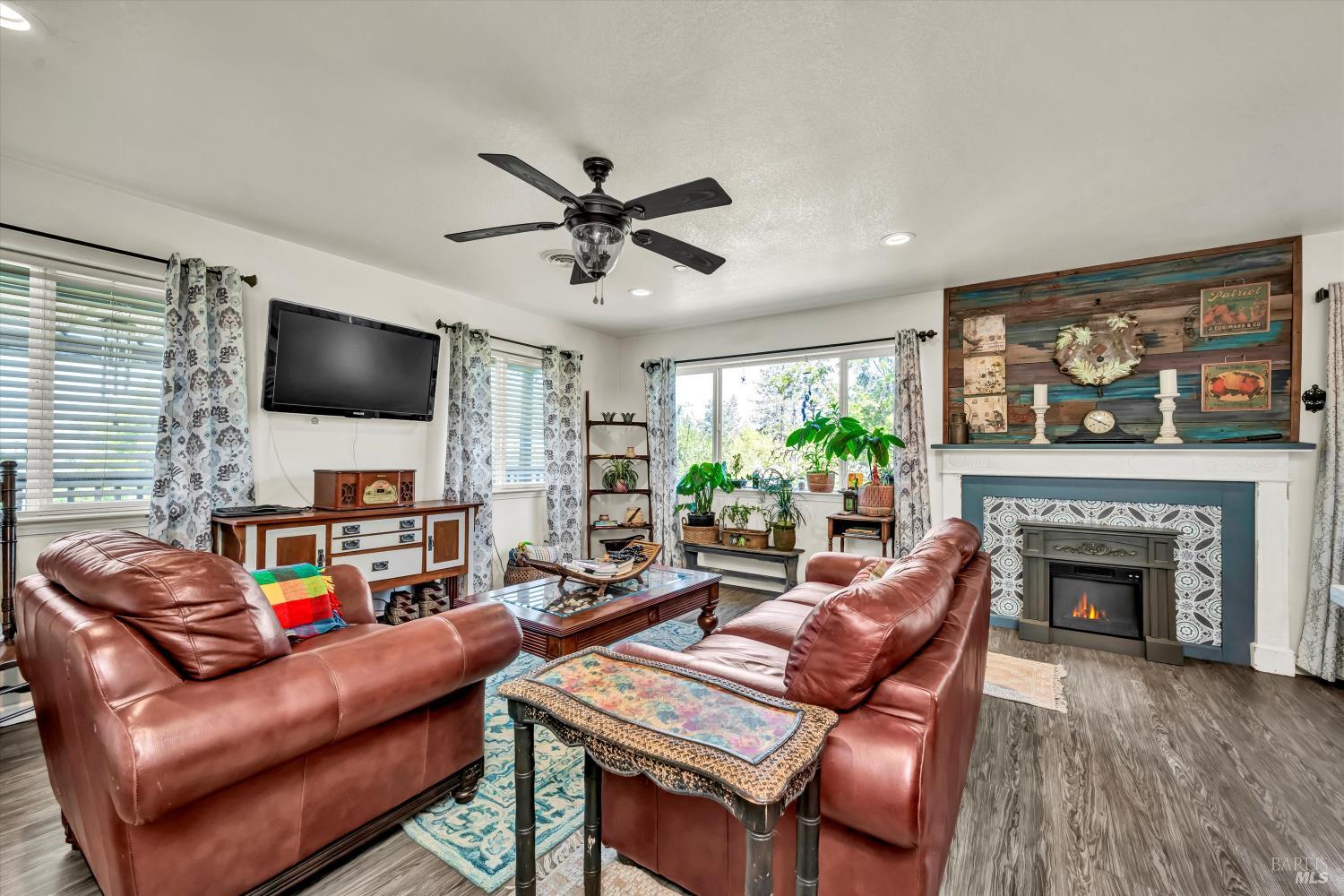 15314 Summit Boulevard Cobb, CA 95426 - Photo 6 of 29 a living room with furniture a fireplace and a flat screen tv