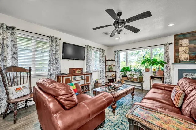 a living room with furniture a large window and a flat screen tv