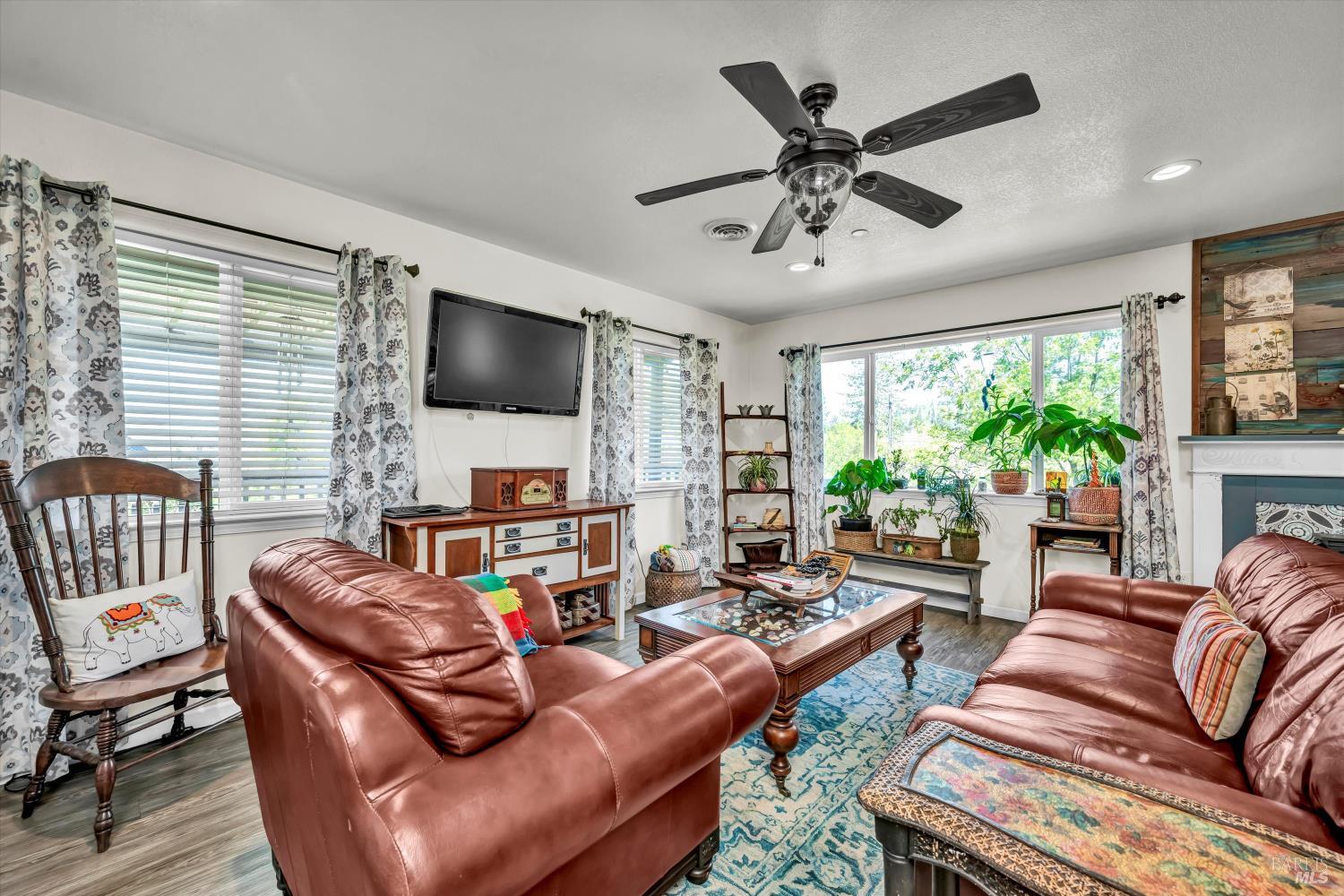 15314 Summit Boulevard Cobb, CA 95426 - Photo 7 of 29 a living room with furniture a large window and a flat screen tv