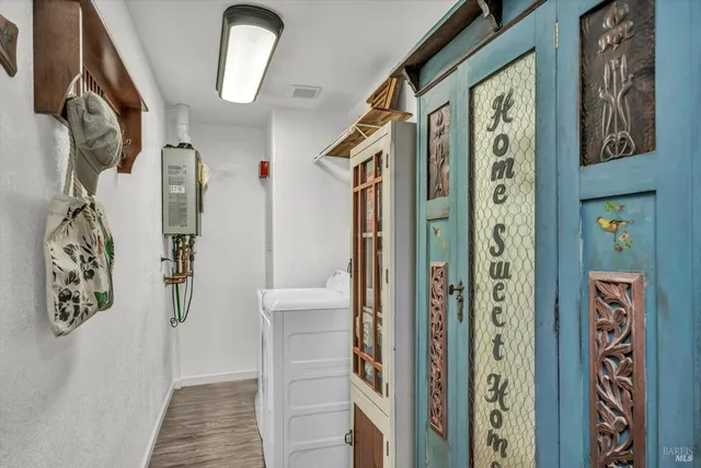a view of an entryway with wooden floor