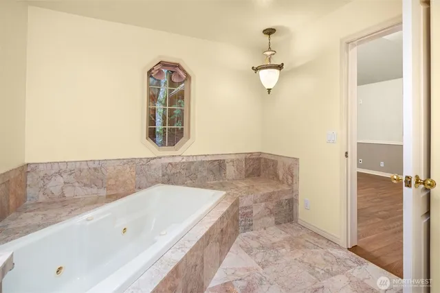 a view of an empty room with a cabinet and a window